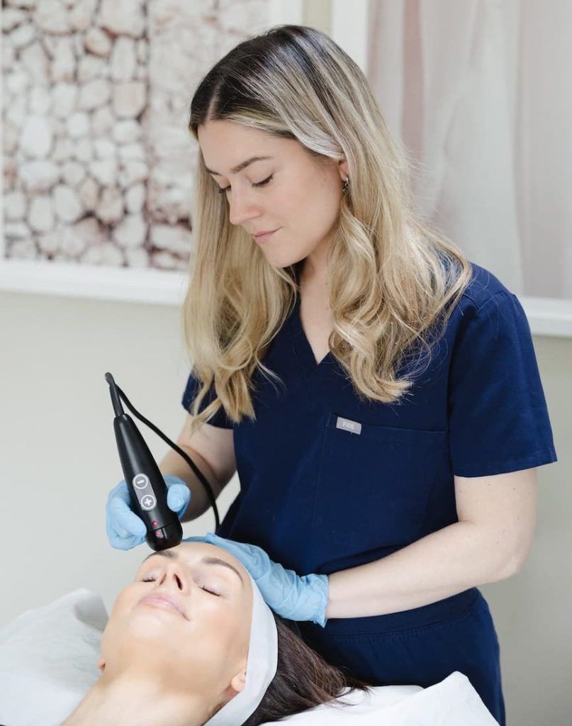 a woman receiving a laser treatment