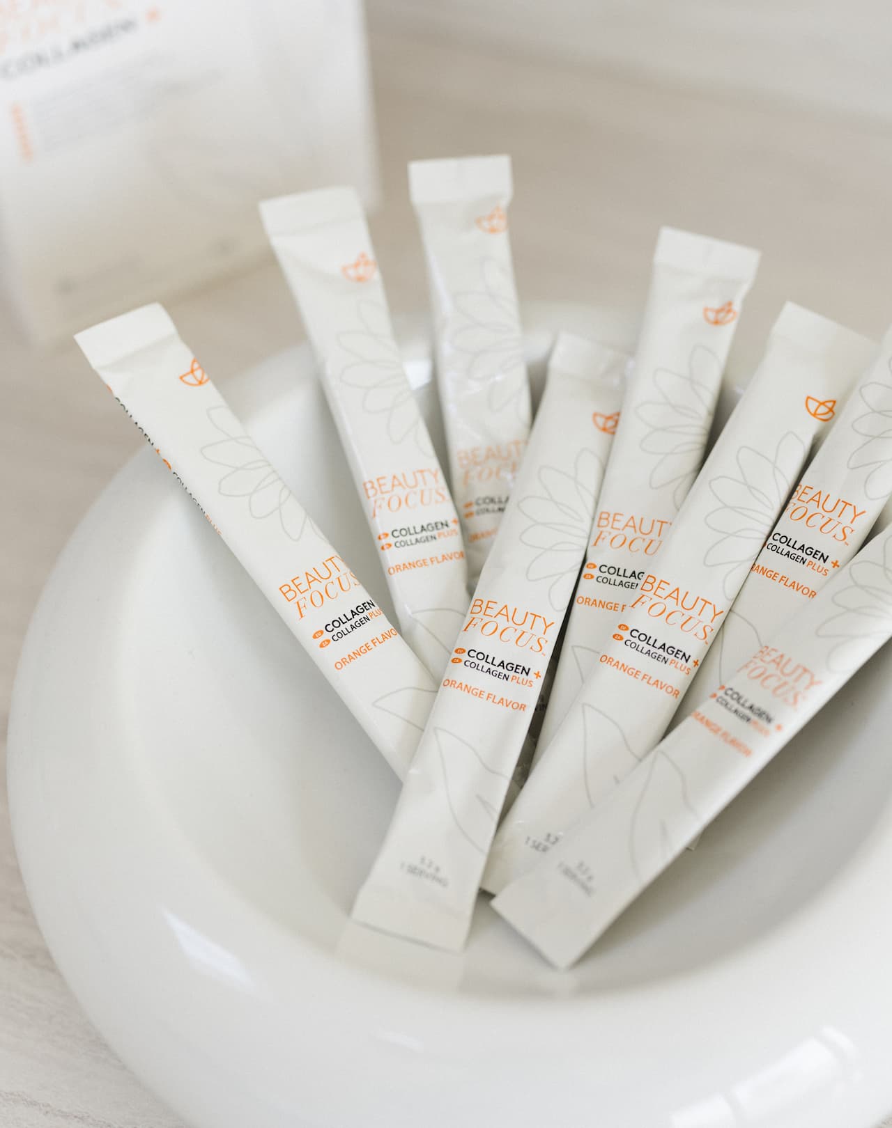 a group of small white tubes with orange and white text on them