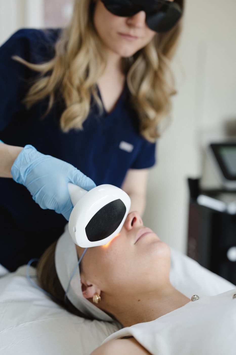 a woman receiving a laser treatment