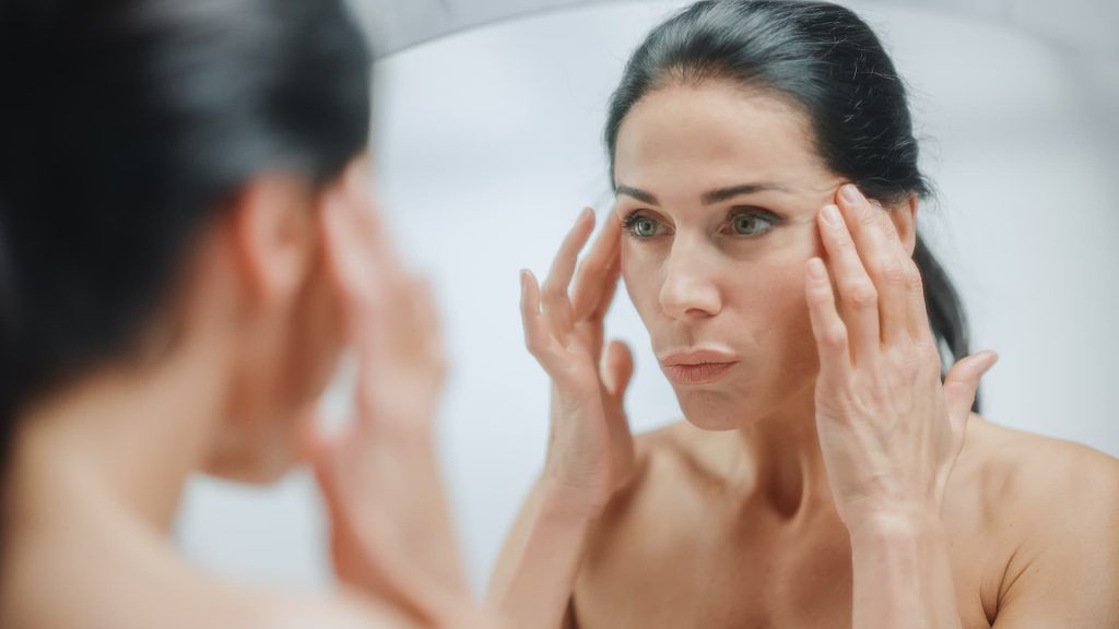 a woman touching her face